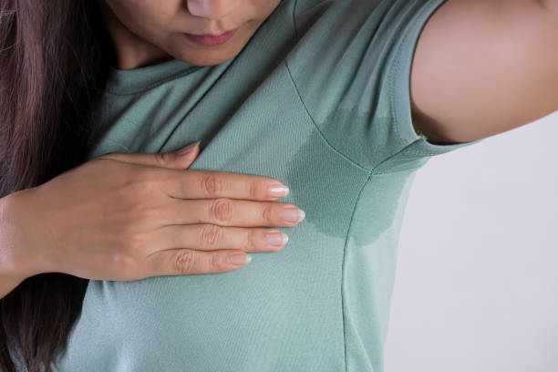 A person showing a perspiration stain on their shirt